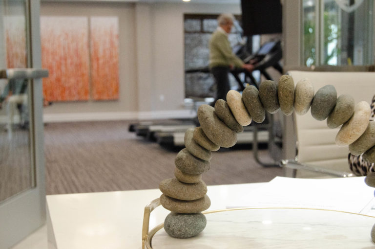 An elegant rock arch display on the front desk, overlooking a resident on the treadmill.