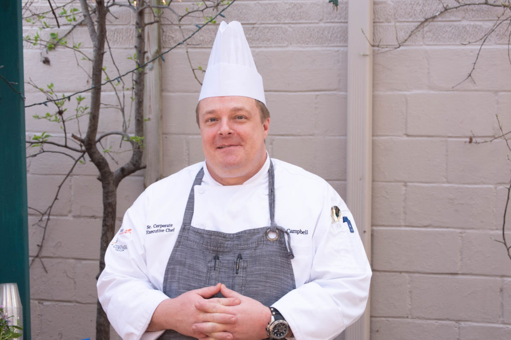 Tiffany Spring's chef standing outside smiling with his chef's hat on.