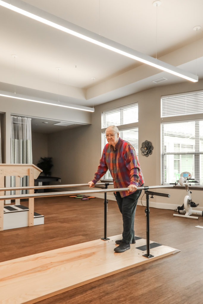 Patient walking with parallel bars